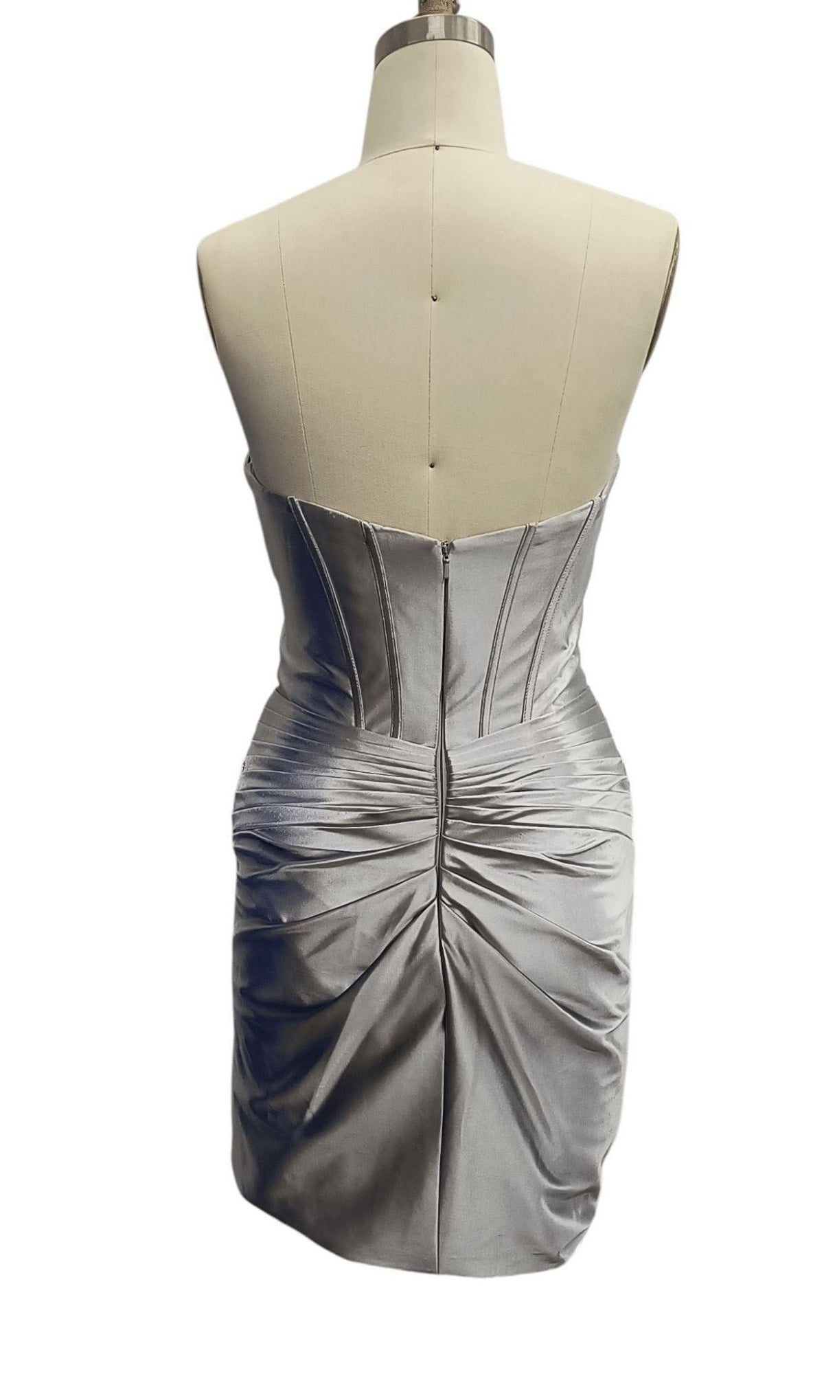 Back view of the Short Satin Corset Hoco Dress: Dave & Johnny 12306 on a dress form, featuring a corset-style bodice, exposed seams, and ruched skirt detail for an elegant mini cocktail look.
